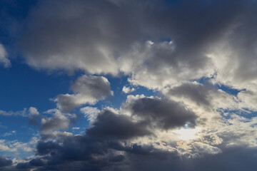 Soft gray-white clouds slowly drift across the autumn sky.