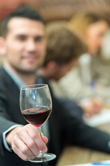 friendly man holding wine glass