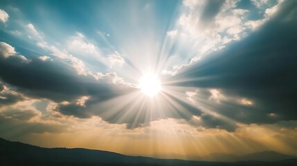 Sunbeams Streaming Through Clouds Over Mountains