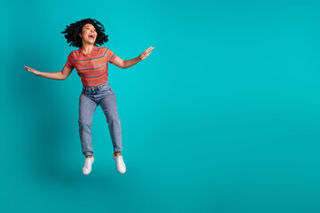 Full body portrait of nice young woman jumping empty space isolated on turquoise color background