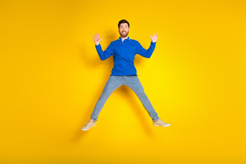 Full body photo of attractive young man jump excited have fun dressed stylish blue clothes isolated...