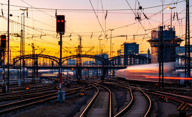 Fast trains leaving and arriving at Munich main station (Germany) in warm evening light. Blurred...