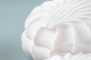 White meringue on blue background. Closeup.
