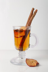 tea with apple, cinnamon, anise in a glass glass, warming drink
