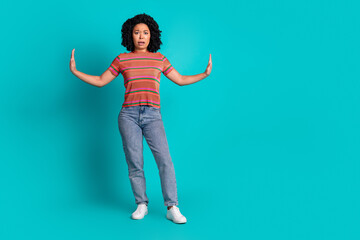 Full size photo of pretty young girl push empty space isolated on teal color background