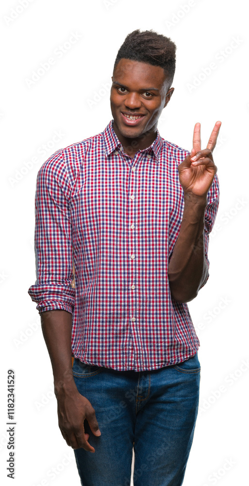 Wall mural Young african american man over isolated background smiling with happy face winking at the camera doing victory sign. Number two.