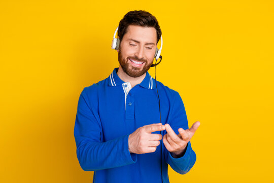 Photo of attractive young man talking phone call center count fingers dressed stylish blue clothes isolated on yellow color background