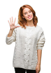 Young beautiful woman over isolated background wearing winter sweater showing and pointing up with...