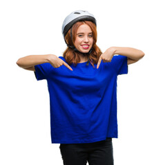 Young beautiful woman wearing cyclist helmet over isolated background looking confident with smile on face, pointing oneself with fingers proud and happy.