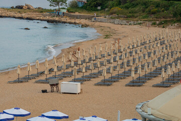 Fototapeta premium Beach deckchairs with umbrellas