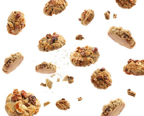 Yummy nut cookies in air on white background