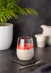 Food photography of breakfast of chia seeds pudding with strawberry puree, berry jam,  healthy vegan dessert, natural food