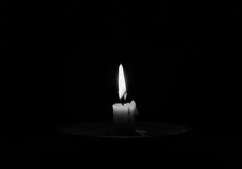 single candle flame, dark background, black and white photography, minimalist, dramatic lighting, contrast, solitude, reflection, atmospheric, moody, contemplative, shadows, simplicity, spiritual, med