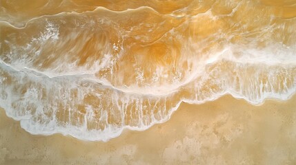 Obraz premium an abstract aerial view of a sandy beach with gentle waves rolling in, highlighted by sunlight, capturing the essence of summer vacation and relaxation