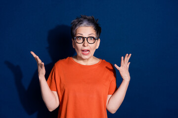 Photo portrait of pretty retired female amazed confused reaction wear trendy orange outfit isolated...