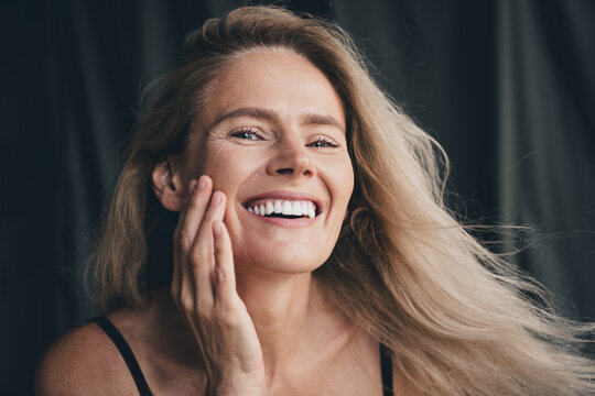 No filter studio photo of sweet pretty woman wear lingerie arm cheek loving herself isolated khaki textile background