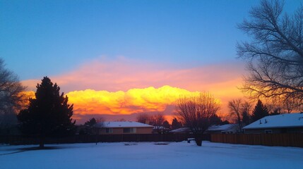 Obraz premium Stunning Sunset Sky over Snowy Suburban Houses