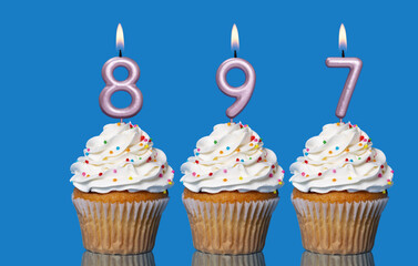 Birthday Cupcakes With Candles Lit Forming The Number 897