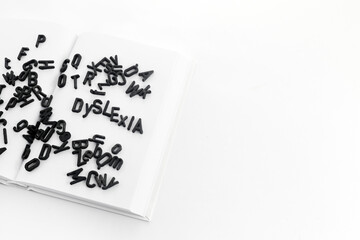 Dyslexia concept. Book filled with jumbled letters