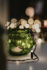 green jar with bokeh