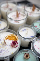 A set of different aroma Soy and coconut wax candles in glass jars. Scented candle. Natural essential candles in a Amber jar. Aromatherapy, wellness and relax in spa product. Close up.