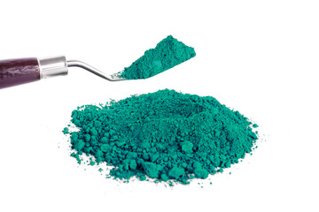 Vibrant Green Pigment Piled Next to a Scoop on a White Background
