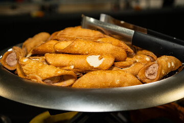 Cannoli platter on a serving tray with tongs