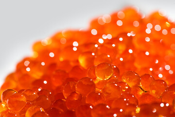 Red caviar background texture close up. Salmon caviar backdrop. Delicious gourmet food. Delicatessen. Texture of caviar. Seafood, macro shot, border design. 