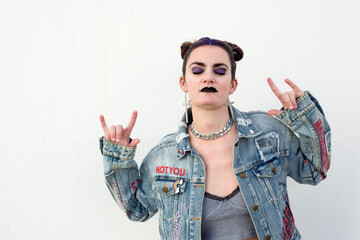 Young punk woman with purple hair and graffiti denim jacket © Ana BG