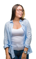 Obraz premium Young caucasian beautiful business woman wearing glasses over isolated background looking away to side with smile on face, natural expression. Laughing confident.