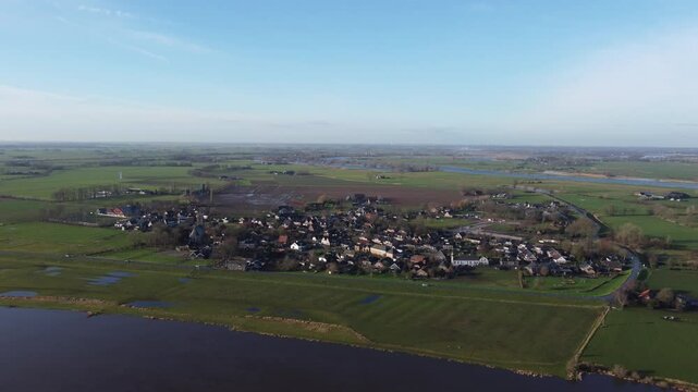 Zalk, the Netherlands - January 8th 2025: Aerial footage of the dutch village of Zalk, next to the river IJssel. Drone is moving towards Zalk.