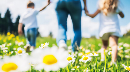 Family walking hand in hand through a field of daisies on a sunny day, enjoying nature and a moment of togetherness in the outdoors.