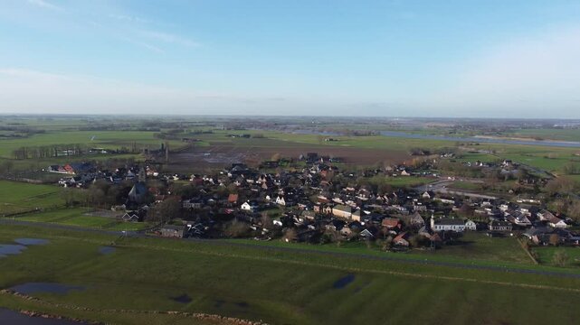 Zalk, the Netherlands - January 8th 2025: Aerial footage of the dutch village of Zalk, next to the river IJssel. Drone is moving backwards away from Zalk.