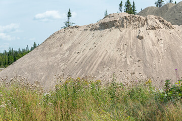 A commercial gravel pit of crushed stone, sand, and aggregate for construction.  The small stones...