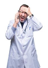 Middle age senior hoary doctor man talking on smartphone over isolated background stressed with hand on head, shocked with shame and surprise face, angry and frustrated. Fear and upset for mistake.