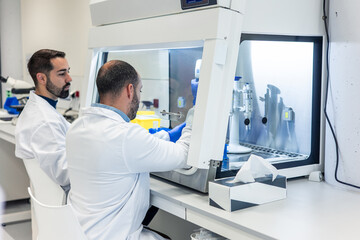 Scientists working with advanced equipment in modern laboratory