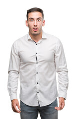 Fototapeta premium Handsome young business man scared in shock with a surprise face, afraid and excited with fear expression