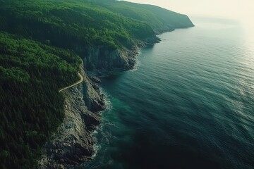 Serene coastal view showcasing rocky cliffs and lush greenery along a winding road under soft...