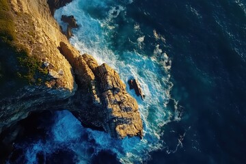 Breathtaking aerial view of rugged cliffs meeting vibrant ocean waves at sunset