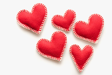 Felt hearts. Red hearts on a white background. February 14. Valentine's Day.