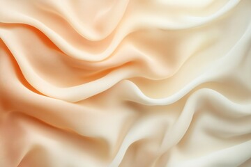 Obraz premium Luxurious peach silk or satin fabric forming gentle curves and waves, creating a smooth, elegant background