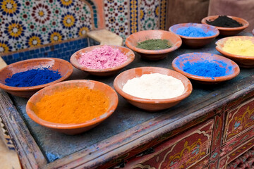 Marrakech, Morocco. Clay bowls of spices and bluing with tile background.