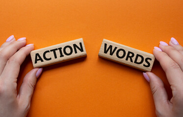 Action or words symbol. Concept word Action or words on wooden blocks. Businessman hand. Beautiful orange background. Business and Action or words concept. Copy space