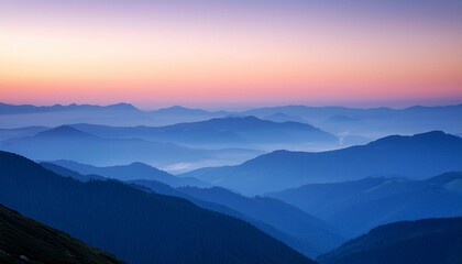Obraz premium a serene landscape of layered blue mountains under a pastel colored sky at dusk showcasing the beauty of nature s tranquility