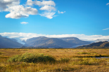 A scenic view of the Skálafellsjökull glacier, an outlet of the Vatnajökull ice cap, surrounded by rugged Icelandic mountains