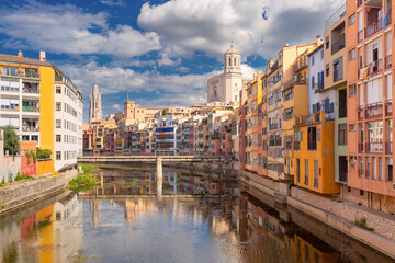 View of Girona Cathedral and colorful buildings along the Onyar River in Girona, Spain