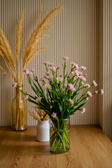 A vase of flowers with orange and pink flowers in it