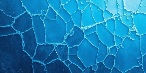 Fototapeta premium Cracked ice texture in blue shades representing cold