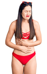 Fototapeta premium Young beautiful caucasian woman wearing bikini with hand on stomach because indigestion, painful illness feeling unwell. ache concept.