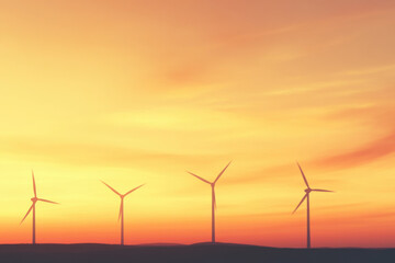 Obraz premium A group of wind turbines are silhouetted against a beautiful sunset